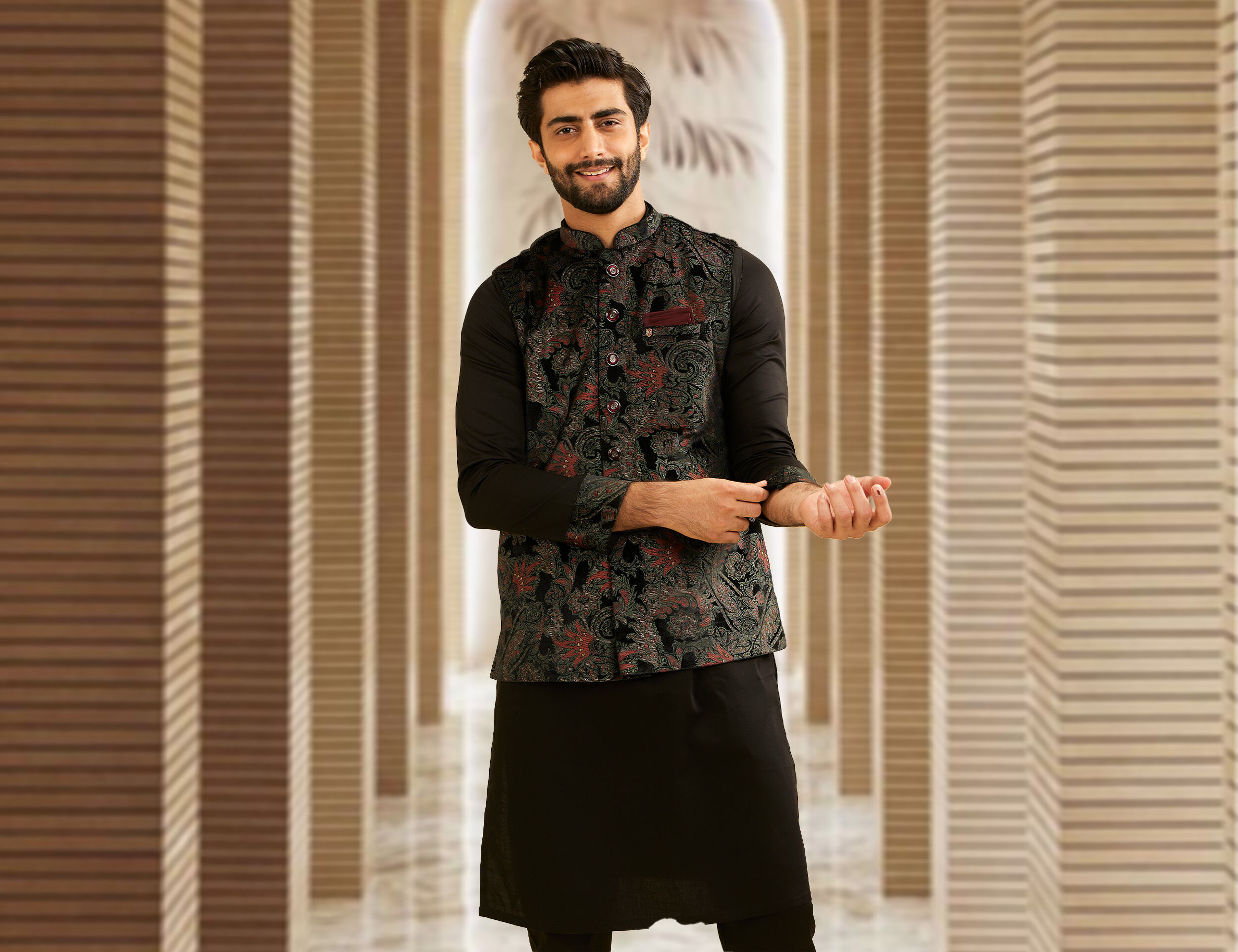 A man wearinng black printed kurta jacket set for sisters wedding 